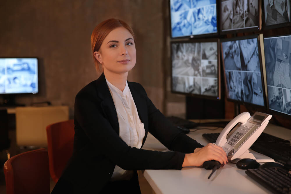 Female security guard working in surveillance room